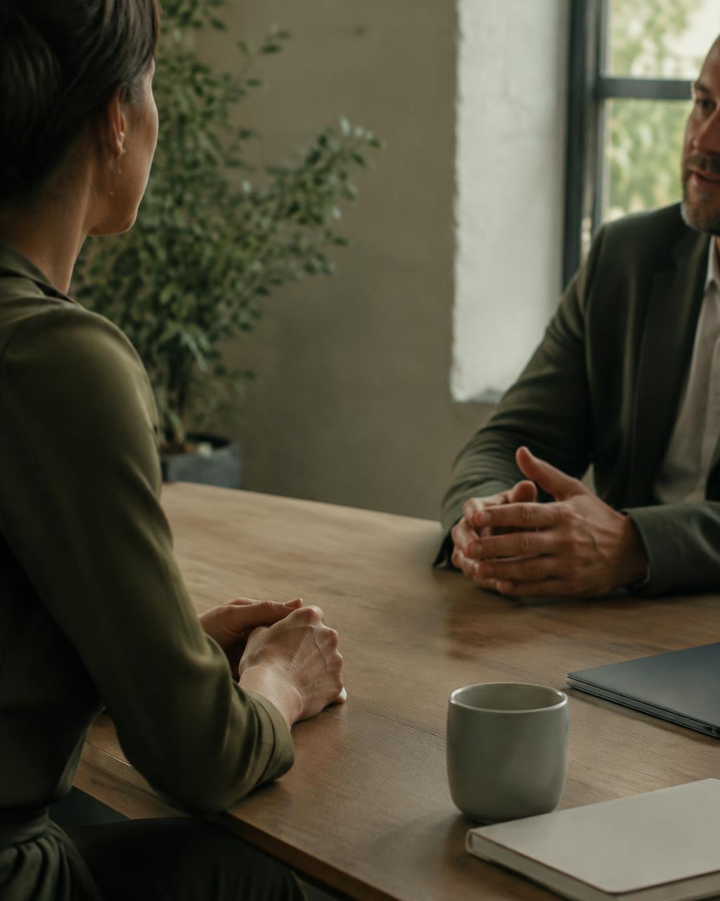 Two people in conversation across a table